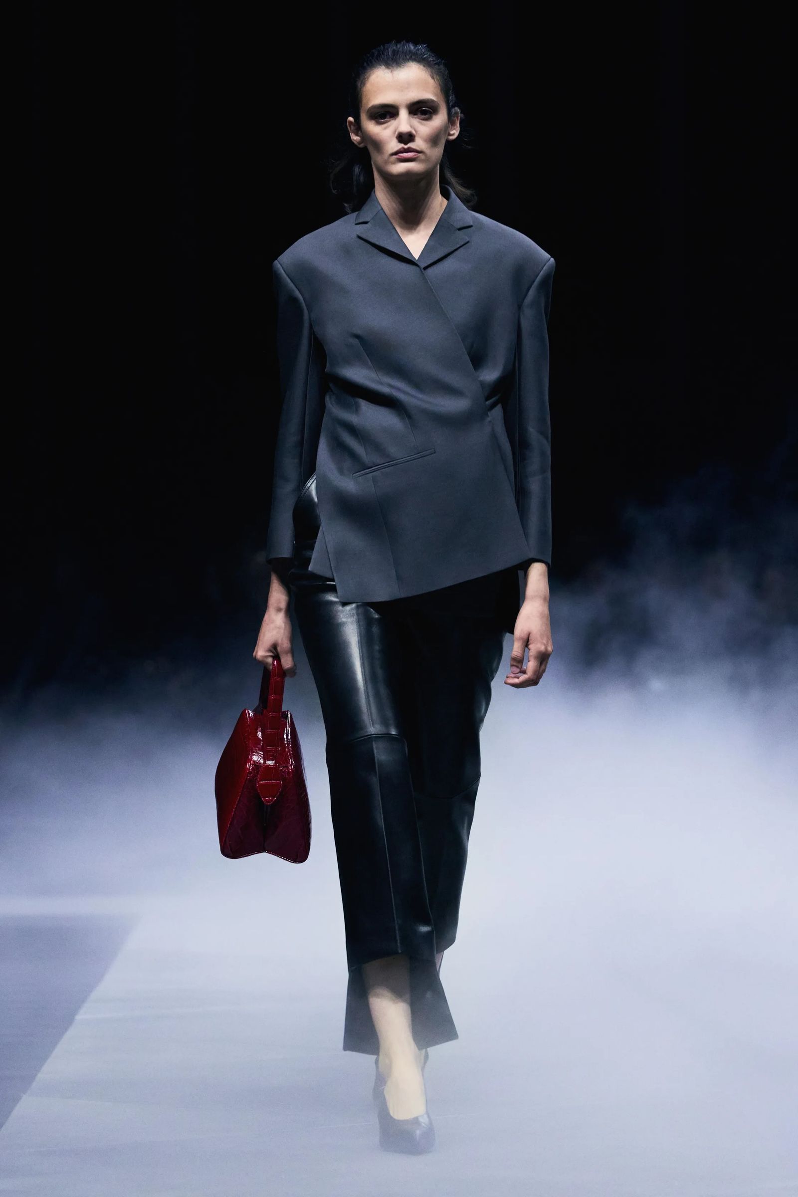 Image may contain Accessories Bag Handbag Fashion Clothing Formal Wear Suit Adult Person Pants and Coat