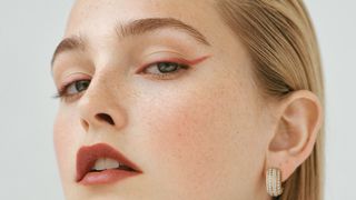 Image may contain Accessories Earring Jewelry Head Person Face Adult Body Part Neck Photography Portrait and Skin