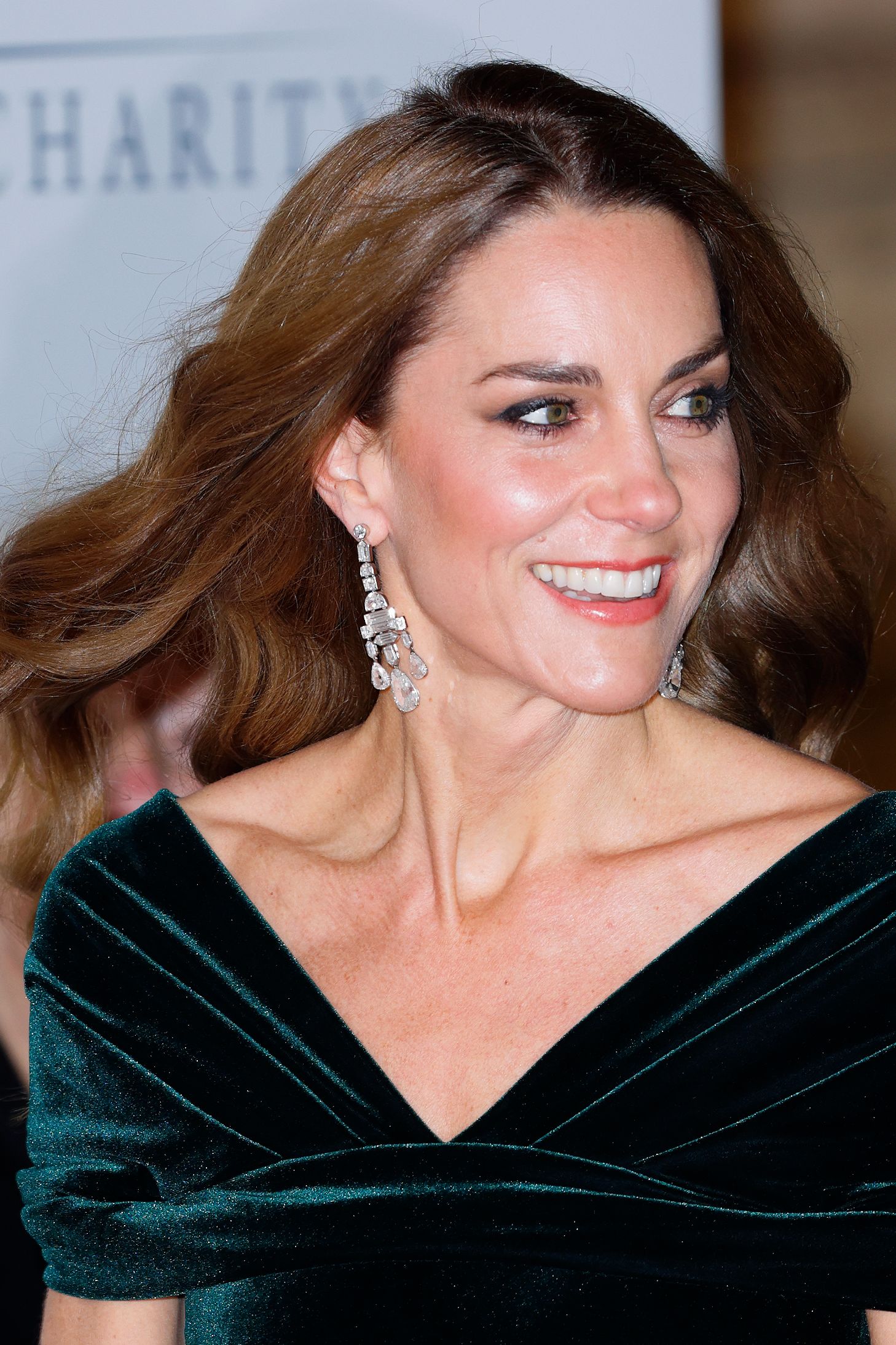 Image may contain Face Happy Head Person Smile Photography Portrait Adult Clothing Dress and Formal Wear