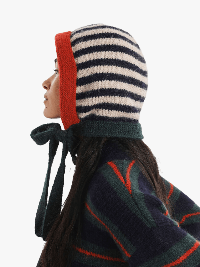 Image may contain: Clothing, Hat, Cap, Bonnet, Adult, Person, and Coat