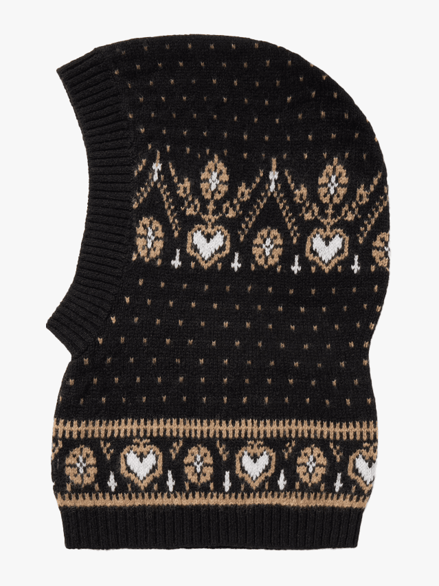 Image may contain: Clothing, Hat, Cap, Beanie, Knitwear, Sweater, and Vest